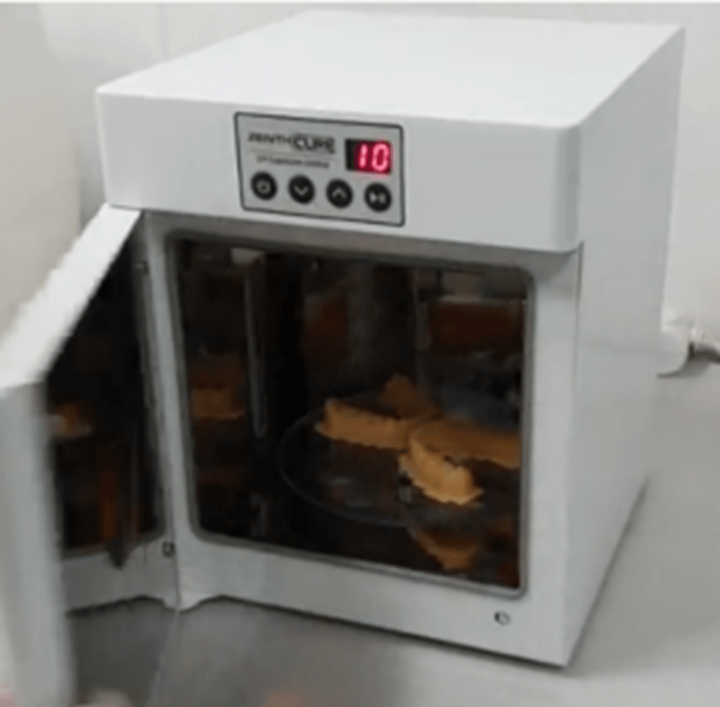 Printouts being cured in the curing equipment